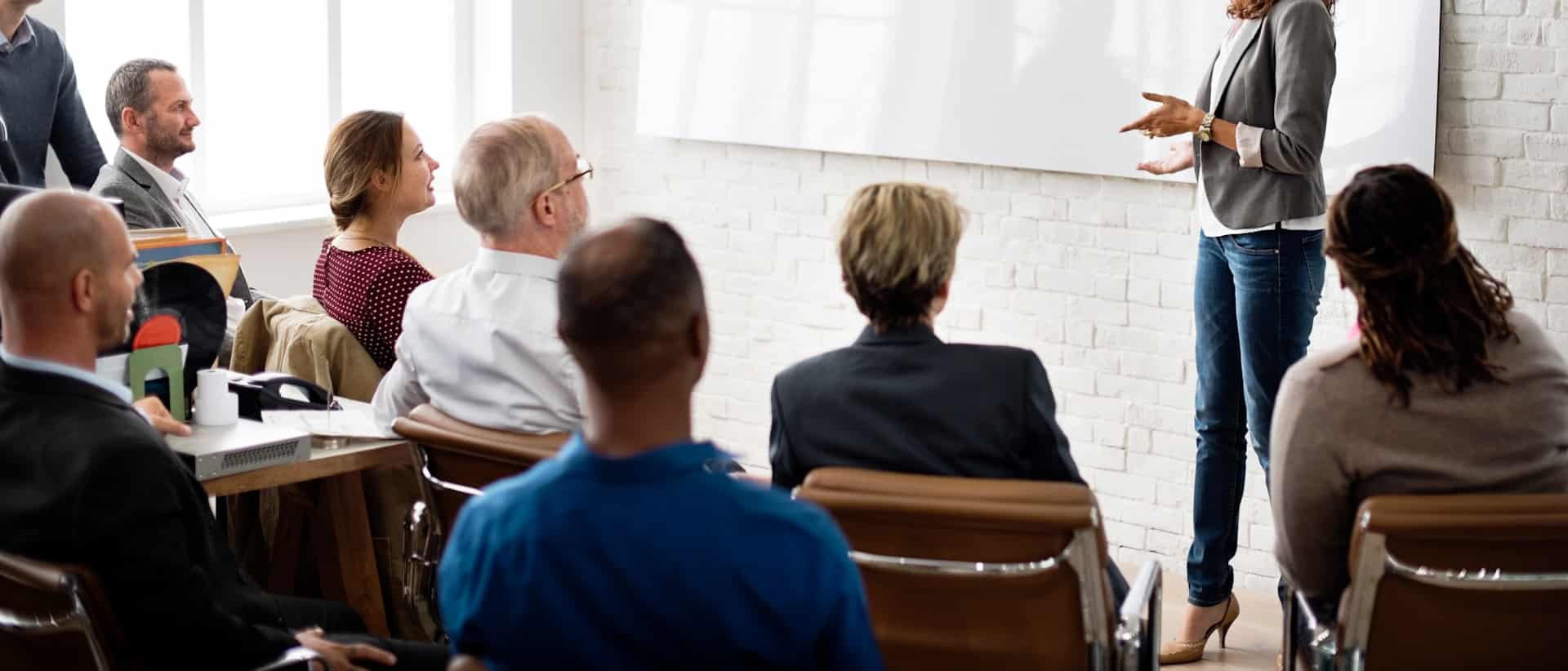 Business presentation for attentive audience in meeting room.